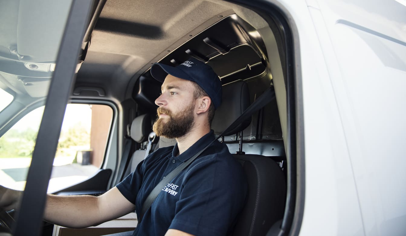 Delivery man sitting in a delivery van