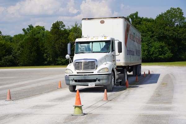 An image of a commercial truck on a student driving range at a TDI campus.