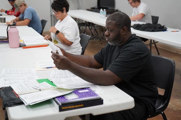 Students in a TDI classroom prepare for the CDL exam.