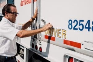 A driver opening their truck as they take advantage of the trucking opportunities amid supply chain shifts